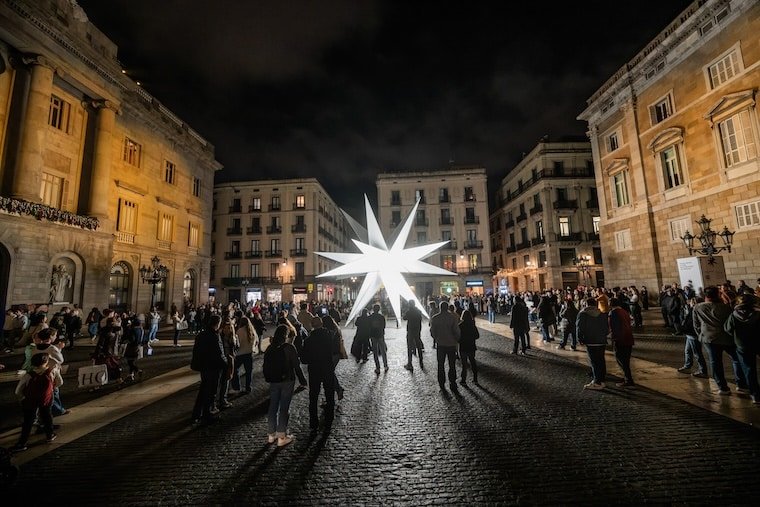 Illuminated star in Plaça Sant Jaume, Barcelona, during the Christmas season