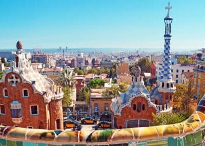 Panoramic view of Park Güell in Barcelona, showcasing Gaudí's iconic colorful mosaics and architectural designs