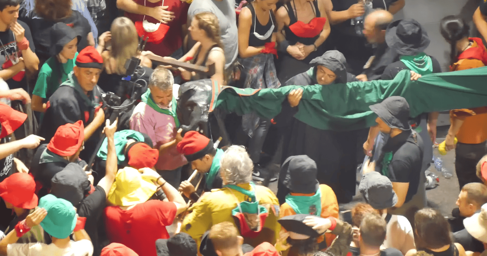 Participants pushing a decorated green dragon figure