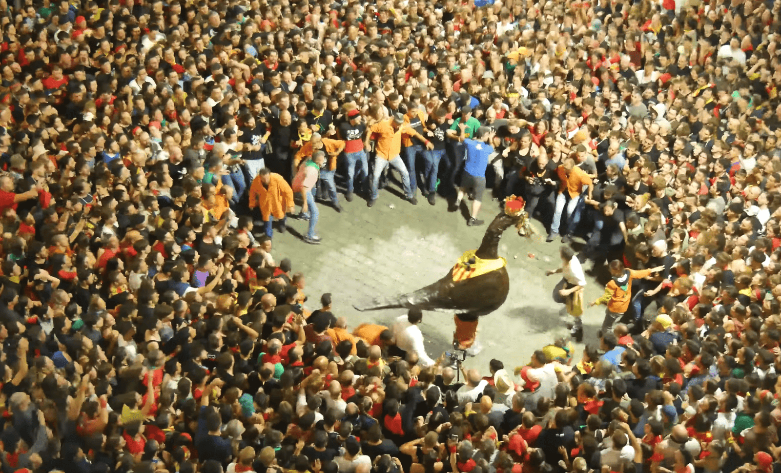 Crowd surrounding a traditional figure during La Patum in Berga