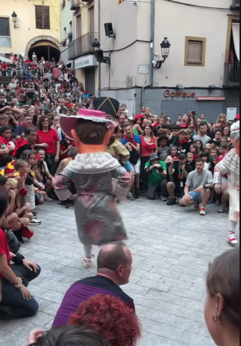 Dwarf character dancing in front of the crowd during La Patum