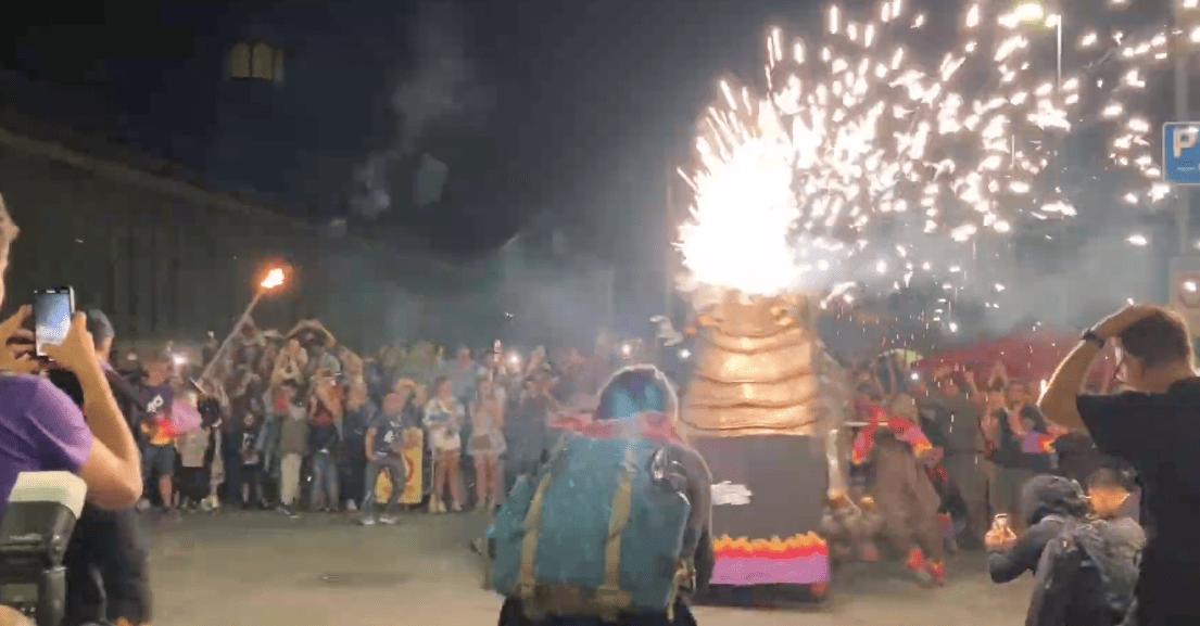 A fire-breathing bestiari figure lights up the night during La Mercè’s correfoc.