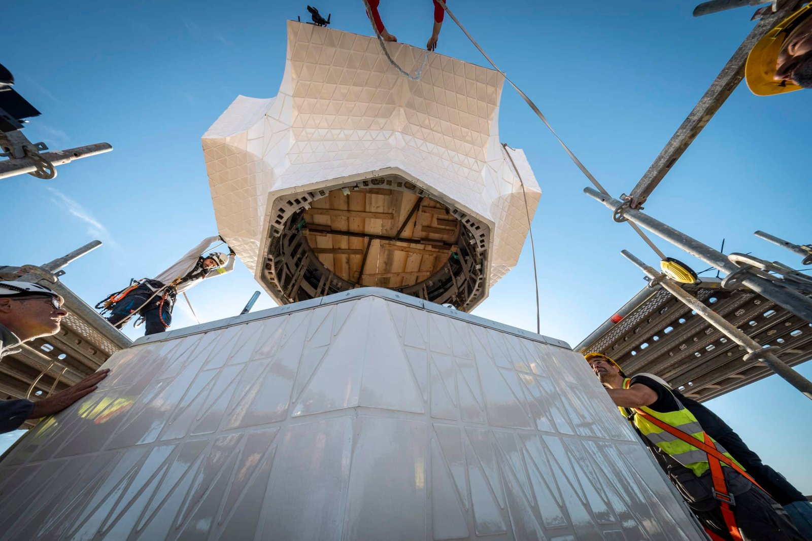 Core of the cross being positioned above the lower arm on the Tower of Jesus Christ at the Sagrada Familia