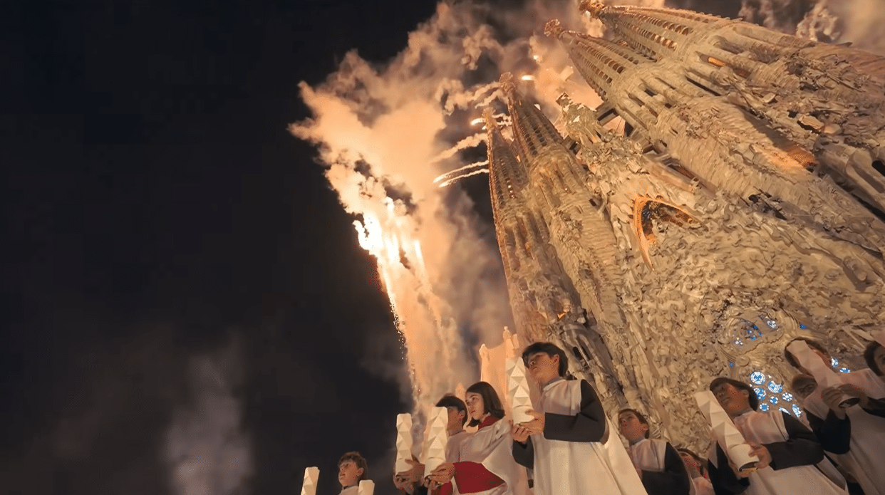 Children's choir performing as fireworks begin above the Sagrada Familia during the Antoni Gaudí centenary celebration.