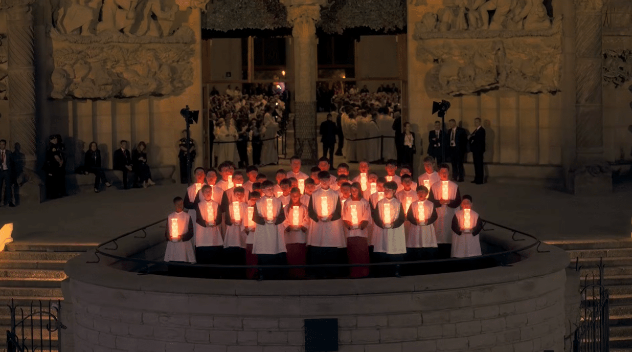 Children's choir gathered with illuminated lanterns at the opening ceremony of the Antoni Gaudí centenary celebration.