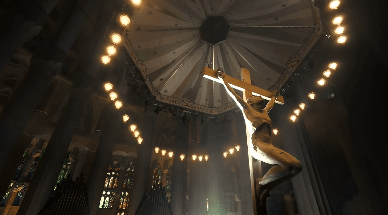 The suspended crucifix inside the Sagrada Familia illuminated during the Gaudí centenary celebration.