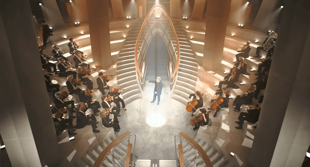 Conductor and orchestra performing inside the Sagrada Familia during the Gaudí centenary celebration.