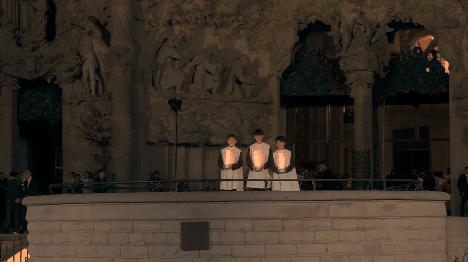 Three young choir singers performing the opening song of the Antoni Gaudí centenary celebration at the Sagrada Familia.