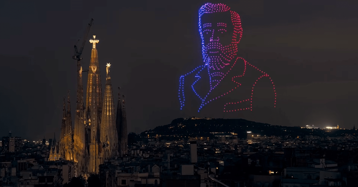 Drone portrait of Antoni Gaudí appearing above the Sagrada Familia during the centenary tribute.