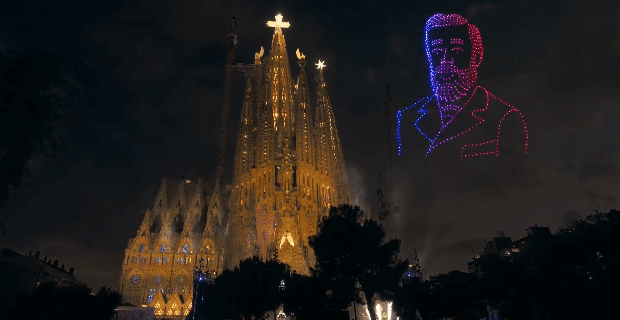 Antoni Gaudí's portrait and the illuminated Sagrada Familia during the centenary tribute.