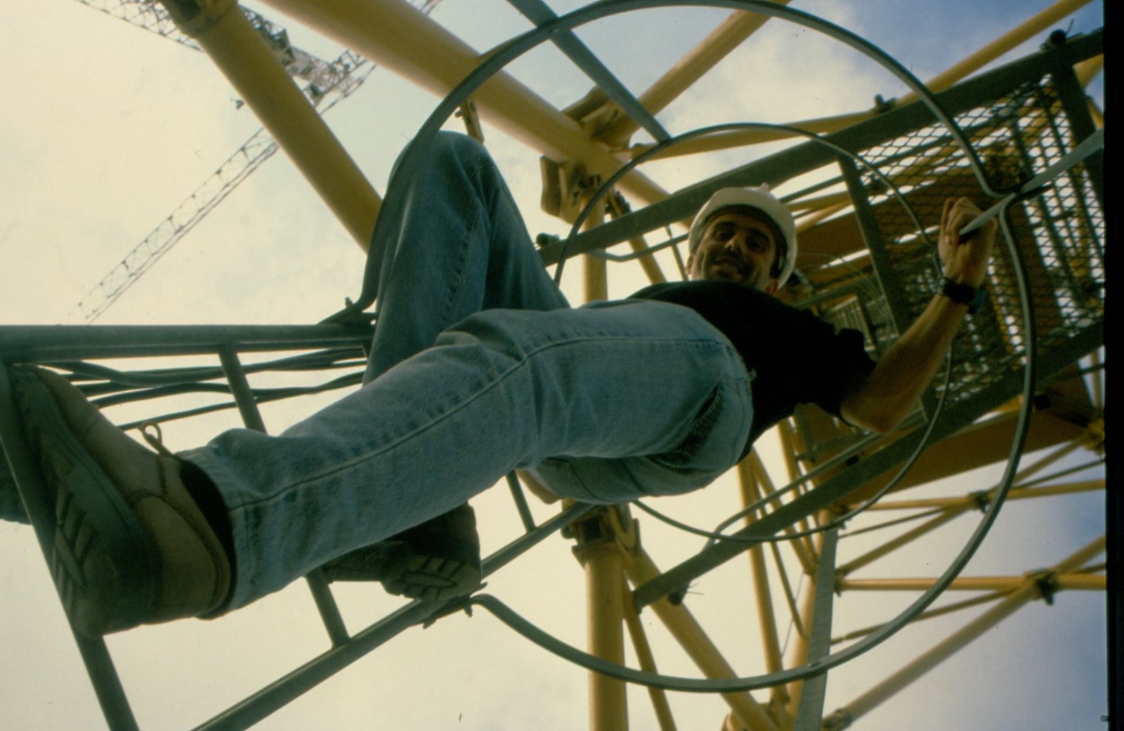 Climbing Toward Gaudí’s Vision: Javier, 1999 Javier climbing the main crane ladder at the Sagrada Familia construction site in 1999