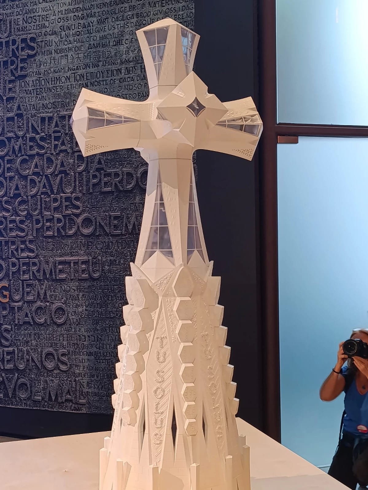 Scale model of the Jesus Tower cross displayed at the Sagrada Família, showing the geometric structure and white finish.