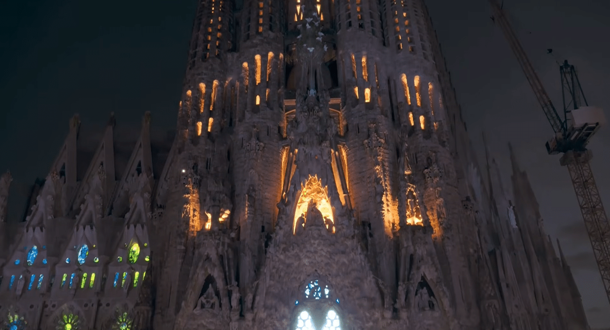The Sagrada Familia illuminated as light ascends the façade during the Antoni Gaudí centenary tribute.