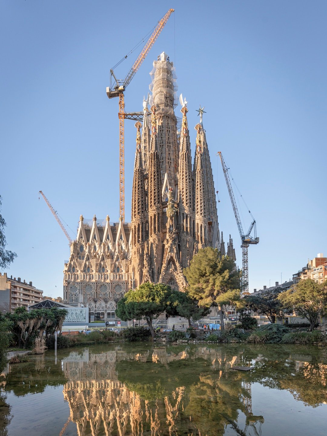 View of the Sagrada Familia from the Nativity Facade with the Tower of Jesus Christ rising above the basilica