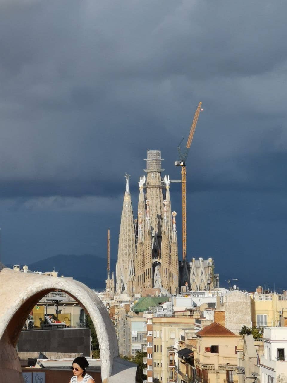 Aerial view of the Sagrada Família under construction, seen from the rooftop of Casa Batlló in Barcelona.