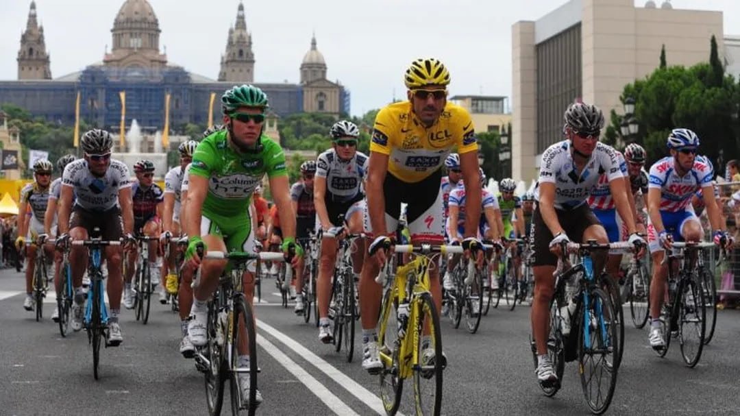 The Tour de France peloton racing through Barcelona with the National Art Museum of Catalonia in the background