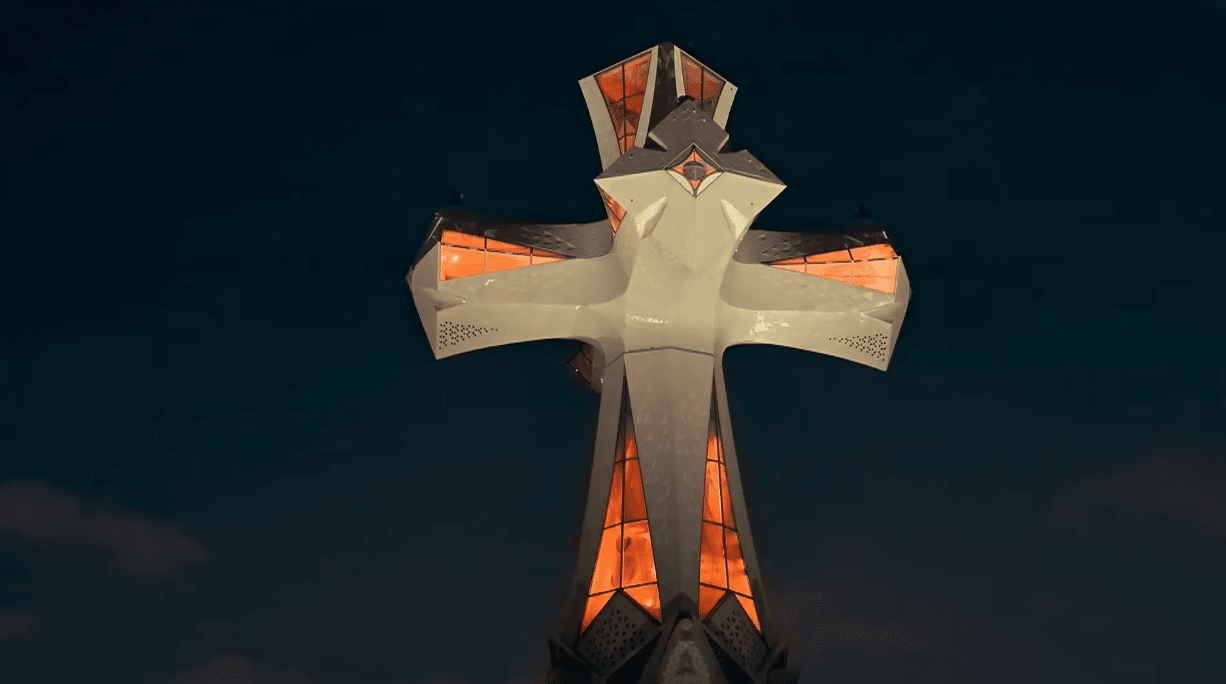 The illuminated cross of the Tower of Jesus at the Sagrada Familia during the centenary tribute to Antoni Gaudí.