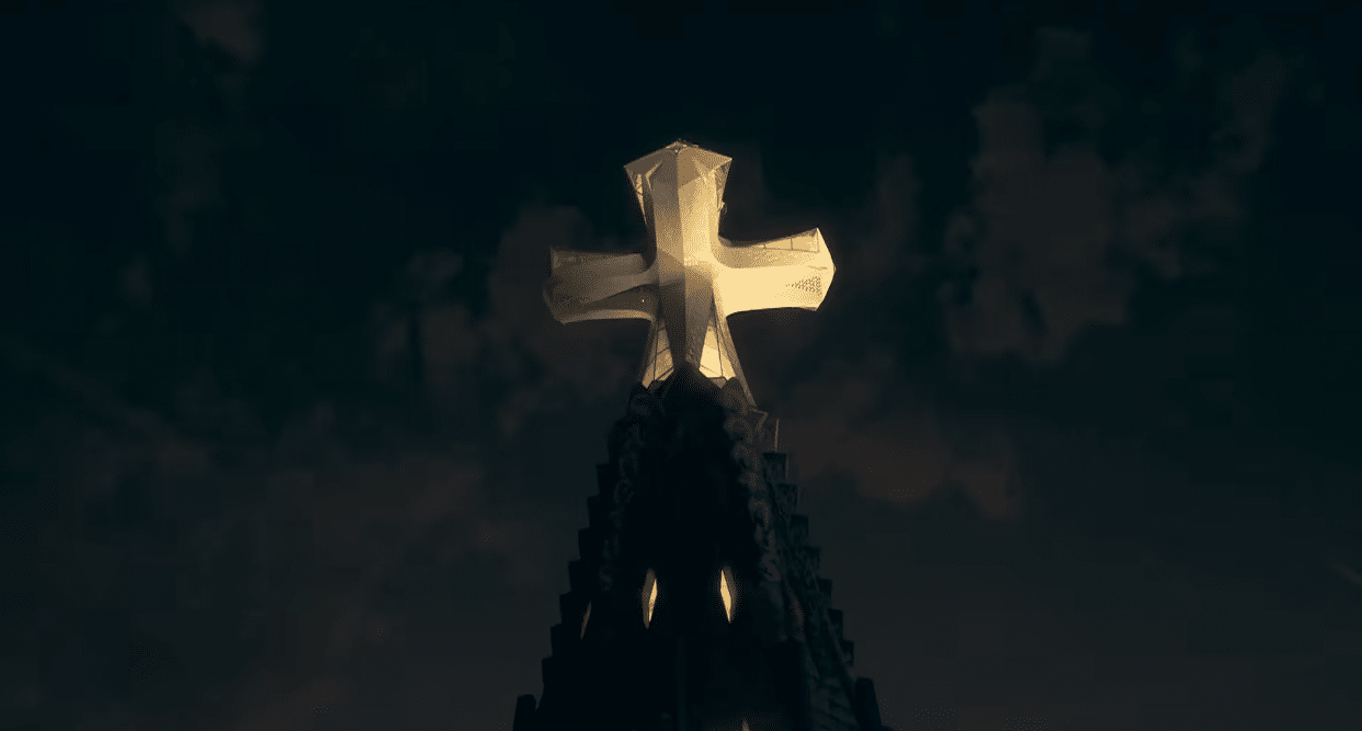 The illuminated cross atop the Tower of Jesus shining over Barcelona during the Gaudí centenary celebration.